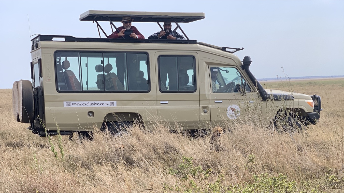 Exclusive Odyssey Travels safari vehicle on the open plains